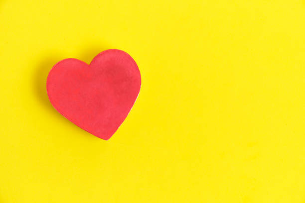 istock Red heart bright yellow background. 1482710689