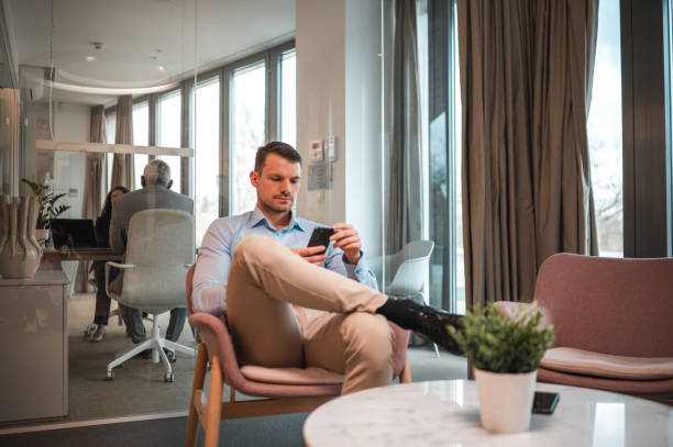 istock Confident Caucasian Job Applicant Waiting For A Job Interview Using Smartphone 1482714308
