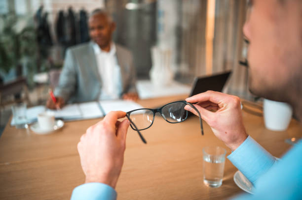 istock Caucasian Businessman Holding Eyeglasses In A Modern Office 1482714334