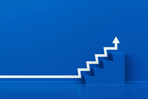 istock White arrow with stair on blue wall background, 3D arrow climbing up over a blue staircase, 3d rendering 1482714595