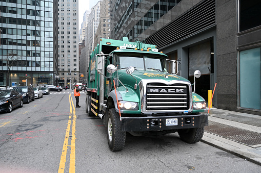 New York City, United States, April 5, 2023 - Cogent's MACK Garbage Truck on the streets of Manhattan, NYC.