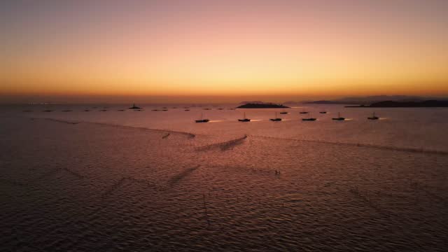 Tidal flats before dawn and fishing boats moored at sea