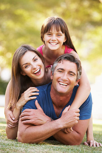 istock Family Lying On Grass In Summer Park 148272323
