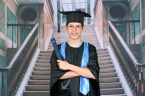 graduating teenager with scholarship and diploma