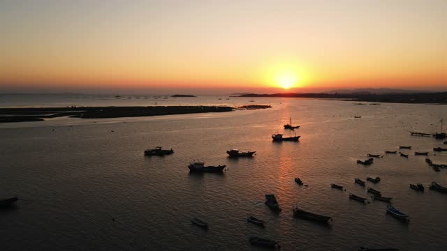 Aerial view of tidal flats by the sea with moored fishing boats