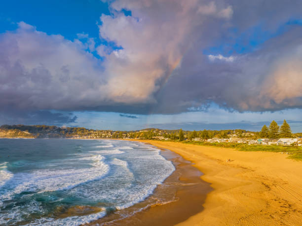 istock Early morning views at the beach with clouds and a rainbow 1482738085