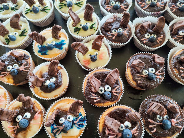 A baking sheet full of Easter bunny cupcakes with funny bunny ears stock photo