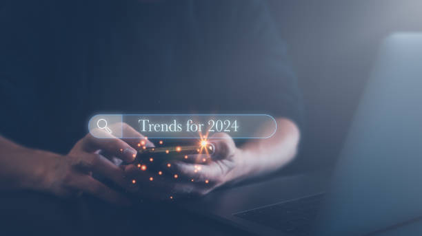 istock man using smartphone searching for 2024 trends to start up new business, update data and planning marketing. Browsing tool bar. Target purpose for change improvement concept 1482742880