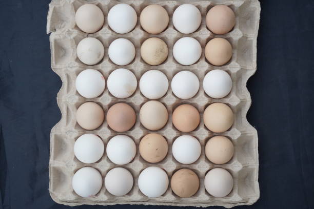 istock Eggs top view. Packing of fresh chicken eggs on marble background. 30 pieces 1482746386