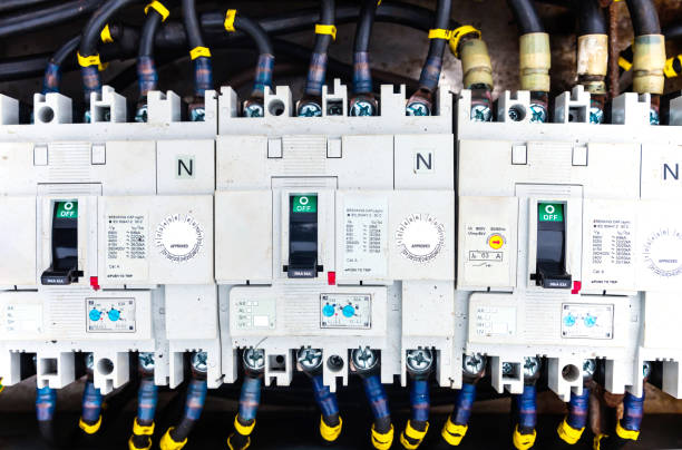 istock Electric cables connected to a distribution block with switches, close-up. 1482749149