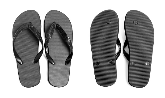Pair of black flip-flops isolated on a white background, front and back view.