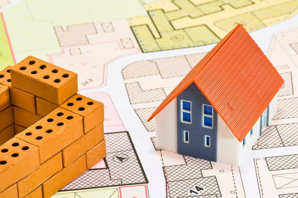 istock General Urban Plan and zoning regulations map with buildings and home model with small terracotta bricks - house construction and building activity concept 1482755762