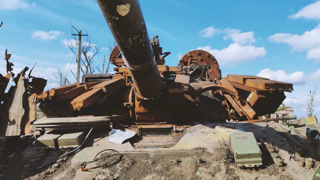 Russian tank destroyed by the Ukrainian military during the invasion of Ukraine. The remains of a blown up Russian tank in the Kherson region, Ukraine 2022 - 2023. The tank is covered with rust and begins to overgrow with plants.