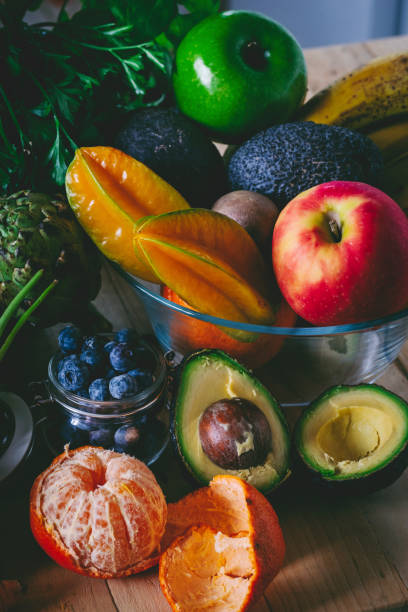istock Vertical composition of fruits and vegetables on the table in dark shadow and bright light. Concept of healthy food and lifestyle. No people. Vitamins and vegetarian vegan nutrition. Local market 1482756149