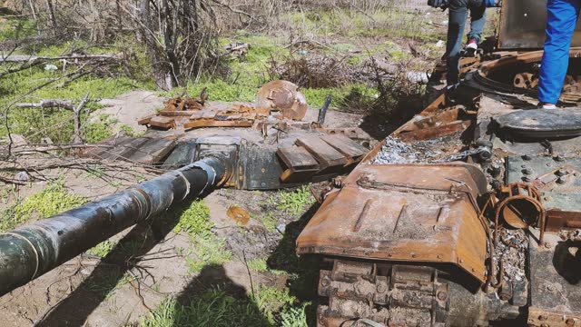 tank turret of a Russian tank is lying around separately from the tank after the explosion. Russian tank destroyed by the Ukrainian military during the invasion of Ukraine. The remains of a blown up Russian tank in the Kherson region, The tank is covered