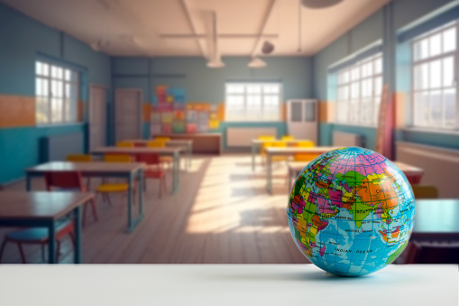 Earth globe model ball map with class room background on tablet in classroom. Concept for global international educaiton or communications, politics environmental for learning world wide. colorful copy space