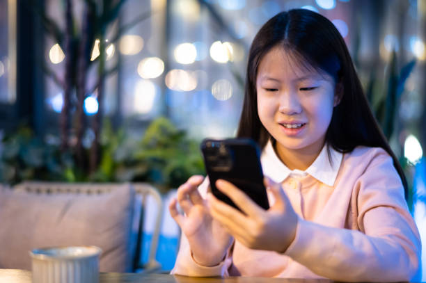 istock Asian girl using smartphone in coffee shop 1482758197