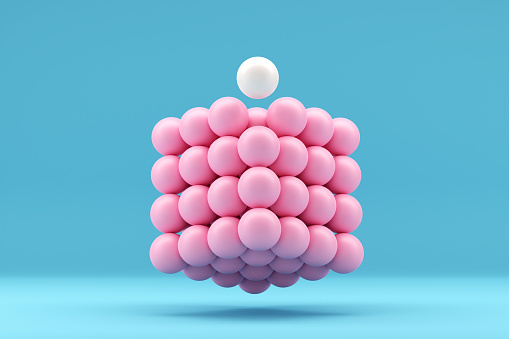 Teamwork, leadership, difference, individuality. Team organization and leading a team. Completing the whole. White ball stands out from the pink spheres in a geometrical cube shape. 3D Rendering.