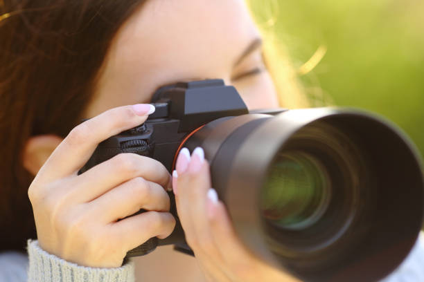 istock Photographer taking pictire with mirrorless camera 1482764300