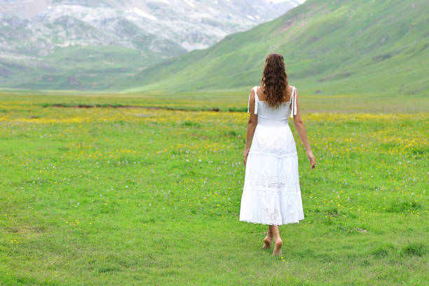 Back view of a woman walking in nature
