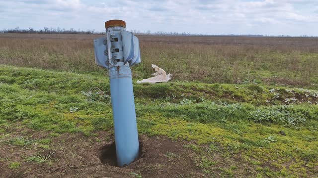 explosive objects - shells, rockets, mines, cartridges, bullets are lying in the fields of Ukraine and are waiting for sappers to clear them. An explosive object in a field in the Kherson region after the Russian occupiers. 2022 -2023, exact date unknown.