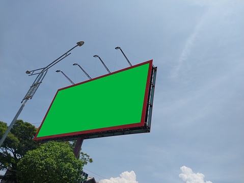 This photo showcases a red-frame billboard captured from a side angle, featuring a unique blue sky with interesting cloud formations as the backdrop. The red frame provides a bold contrast against the serene blue sky, creating an eye-catching display that's hard to miss. The billboard's side angle also allows for creative messaging and designs that can utilize the unique shape of the display. Consider the benefits of utilizing bold and attention-grabbing red-frame billboards for your advertising needs and explore the endless possibilities of creating a memorable marketing campaign against unique and striking backdrops like the one captured in this photo.