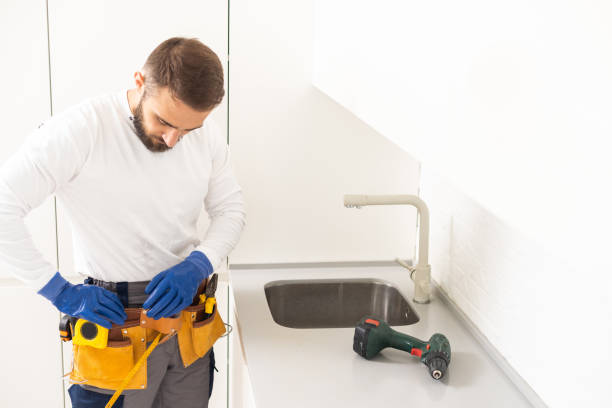 istock Side View Of A Plumber Fixing Water Tap In Kitchen 1482766515