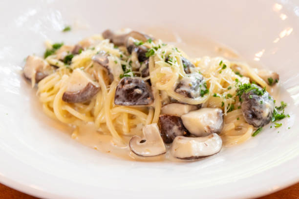 istock Vegan spaghetti mushroom carbonara on white plate. 1482766523