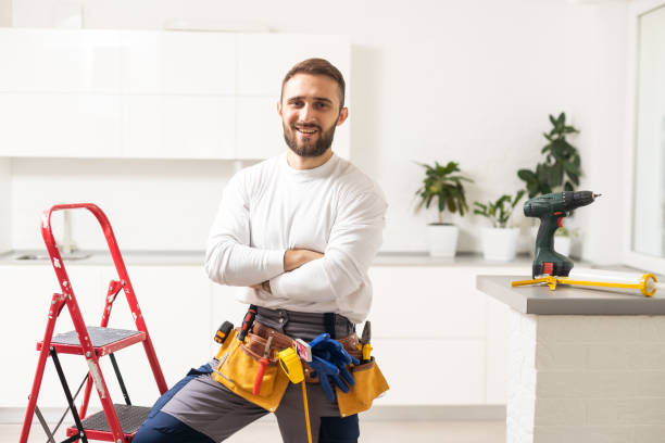 Male Worker Sitting on the Ladder on Construction Site. Repair Home and House Renovation Service stock photo