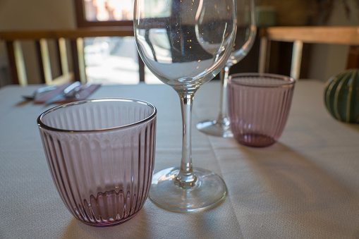 Pink glasses and green decoration on table of restaurant
