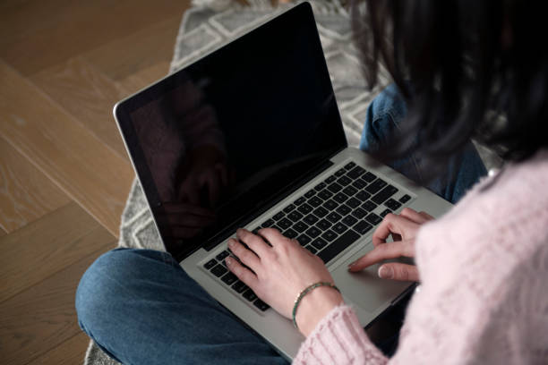 istock A woman using and typing on laptop with blank desktop screen 1482768420
