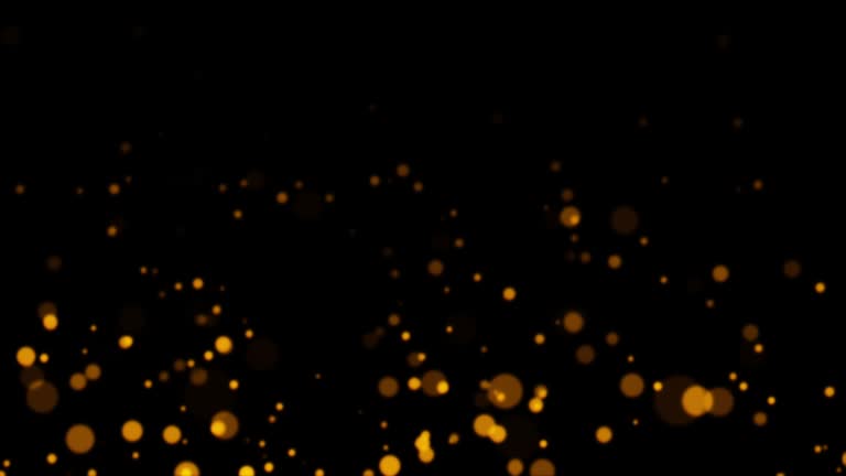 Loop motion graphics of glow orange bokeh particles flow up on black abstract background.