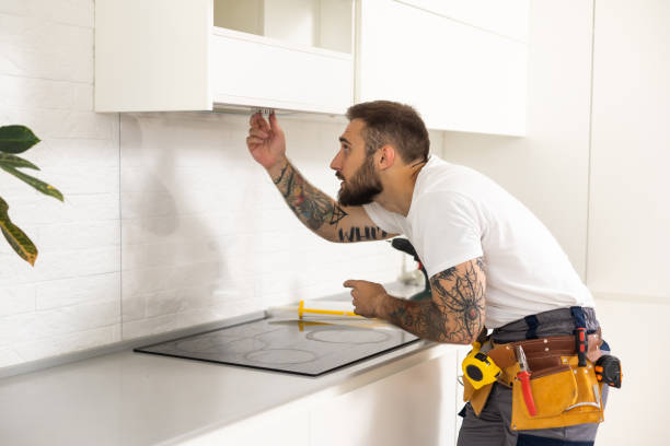 istock Male Worker Fixing Kitchen Hood With Screwdriver In Kitchen. 1482769643
