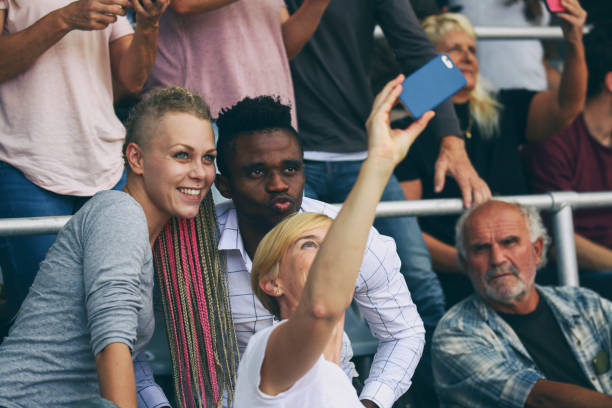 istock People taking a selfies at a footbal match 1482769833