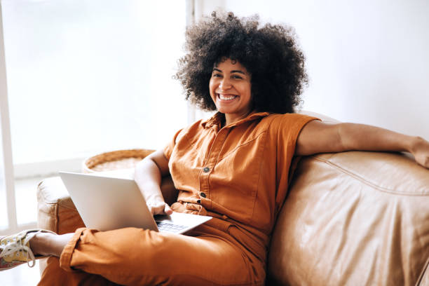 istock Cheerful young businesswoman smiling while sitting on a couch 1482769866