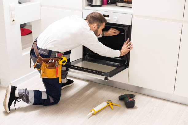 istock Young Male Technician Repairing Oven In Kitchen 1482770088