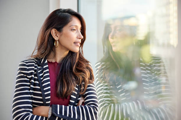 istock Young businesswoman taking a break and daydreaming 1482770361