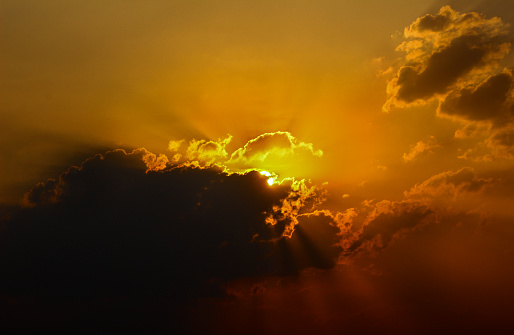 Sunset behind Clouds - stock photo