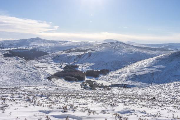 istock Snow-covered slope and mountains with a sun shining over them 1482770725