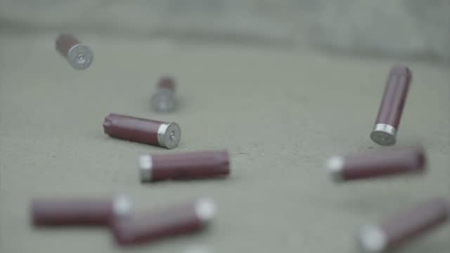 Bullet casings on asphalt stock video
