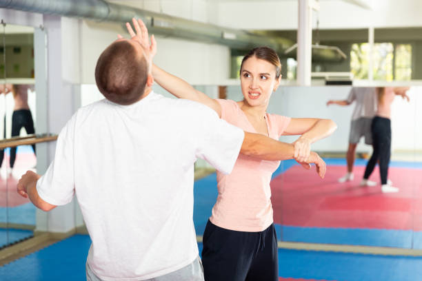 istock Young woman exercising chin strike during self-protection training 1482773281