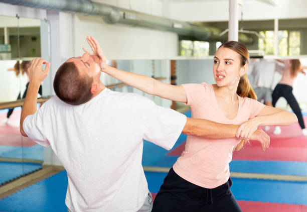 istock Young woman exercising chin strike during self-protection training 1482773283