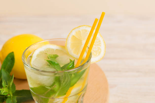 istock Mojito cocktail. Refreshing mojito cocktail with lime, lemon and mint in a tall glass with a stick 1482776669
