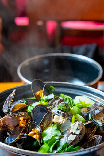 A closeup of a delicious steamed mussel casserole in a Belgian restaurant. Healthy food.