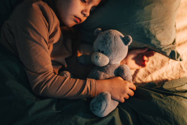 istock Little Girl Sleeping With Her Teddy Bear At Night 1482780917
