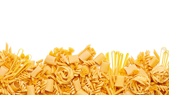 Border of different type of pasta isolated on white background