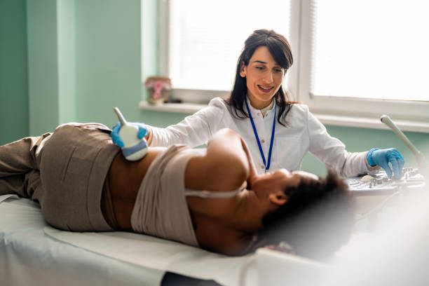 Medical specialist conducts an examination of the kidneys of patient stock photo