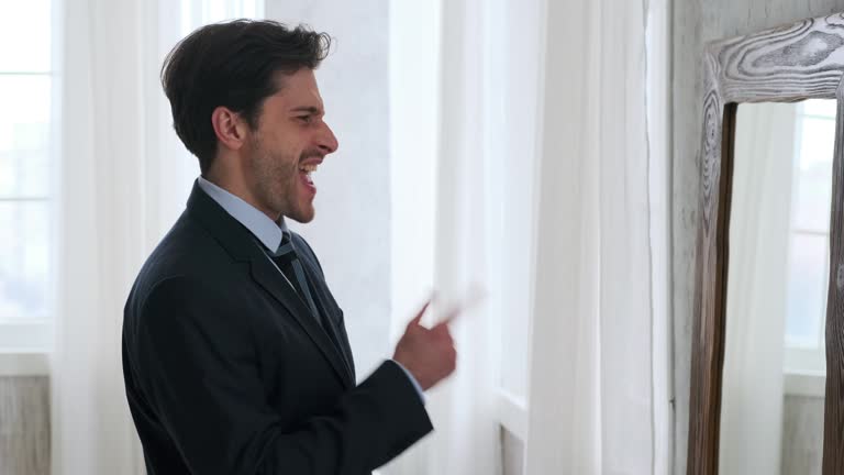 Profile of handsome man getting ready in front of a mirror