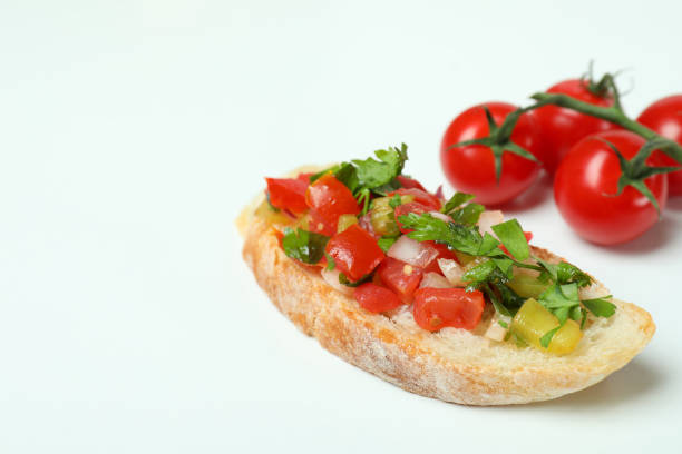 Delicious italian snack bruschetta and tomatoes on white background