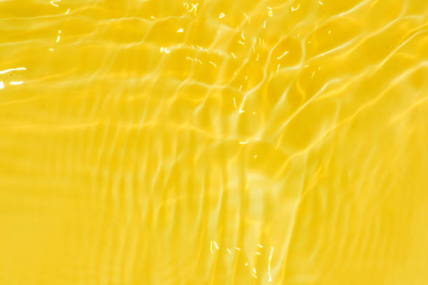 istock Defocus blurred transparent yellow colored clear calm water surface texture with splashes and bubbles. Trendy abstract nature background. Water waves in sunlight with copy space. Yellow water shine 1482788831